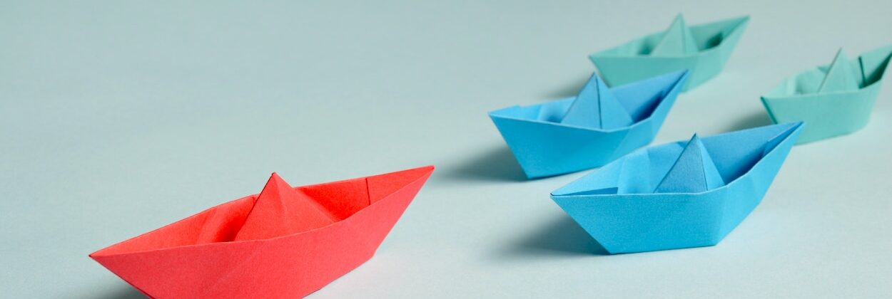 paper boats in a race; select the leader