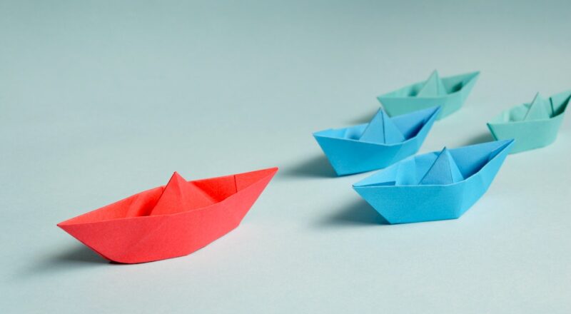 paper boats in a race; select the leader
