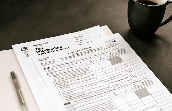 income tax form, cup of coffee, pen
