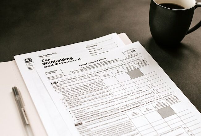 income tax form, cup of coffee, pen