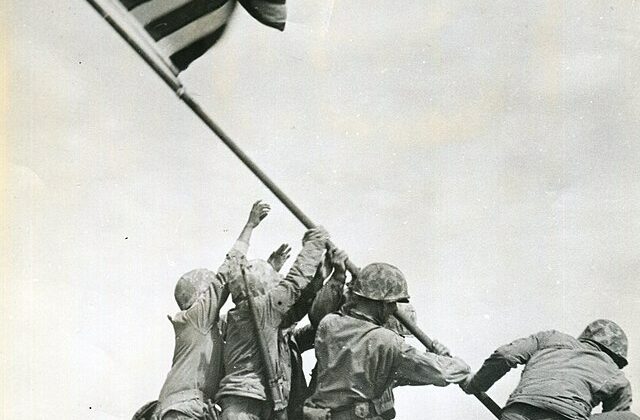Soldiers raising the American flag