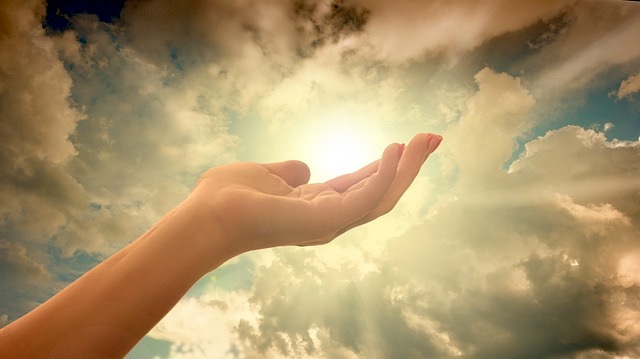open hand in sun rays depicting religion and freedom