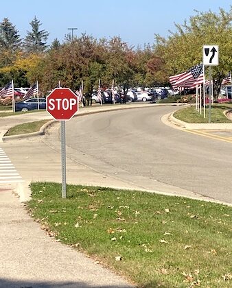 American flags and stop sign