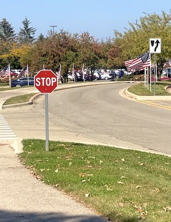 American flags and stop sign